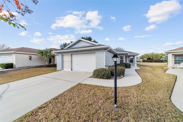 ranch-style house featuring a garage and a front lawn