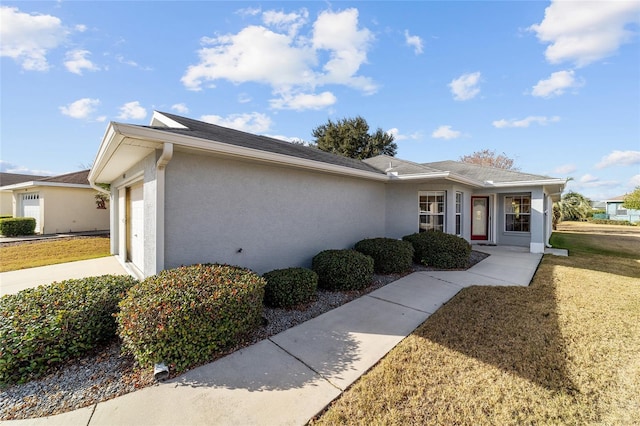 view of front of home featuring a garage and a front lawn