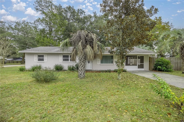 ranch-style home featuring a front yard