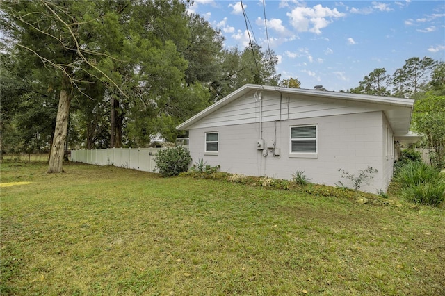 view of side of property with a yard