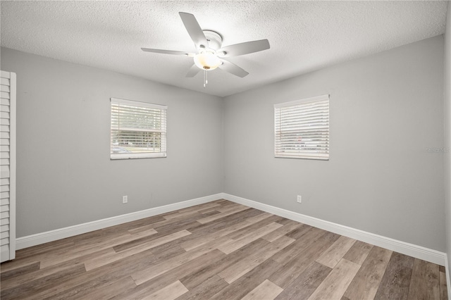 spare room featuring ceiling fan, a textured ceiling, and light hardwood / wood-style floors