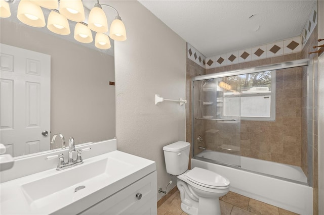 full bathroom with a textured ceiling, enclosed tub / shower combo, tile patterned floors, vanity, and toilet