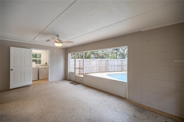 interior space featuring washer and dryer and ceiling fan