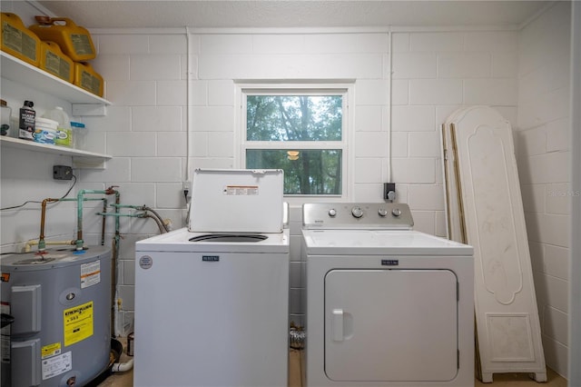 laundry area featuring water heater and washer and dryer