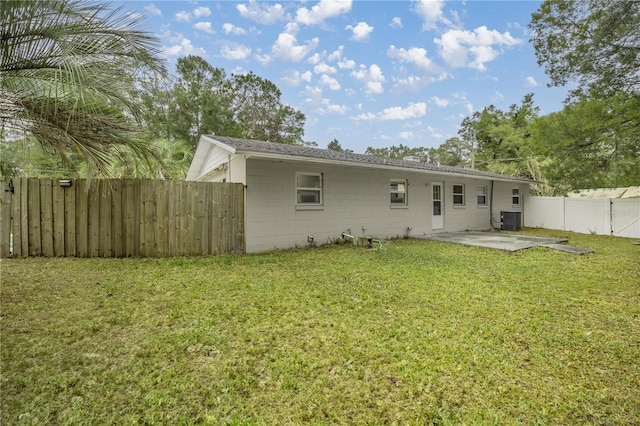 back of house with a yard, a patio, and central air condition unit