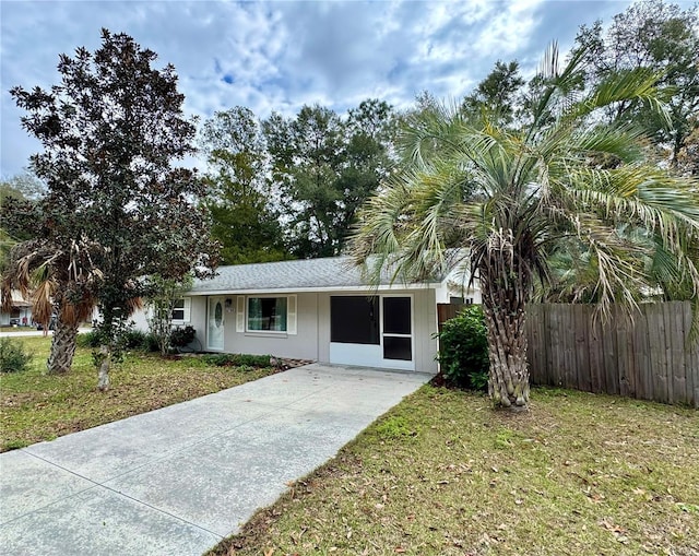 ranch-style house with a front lawn