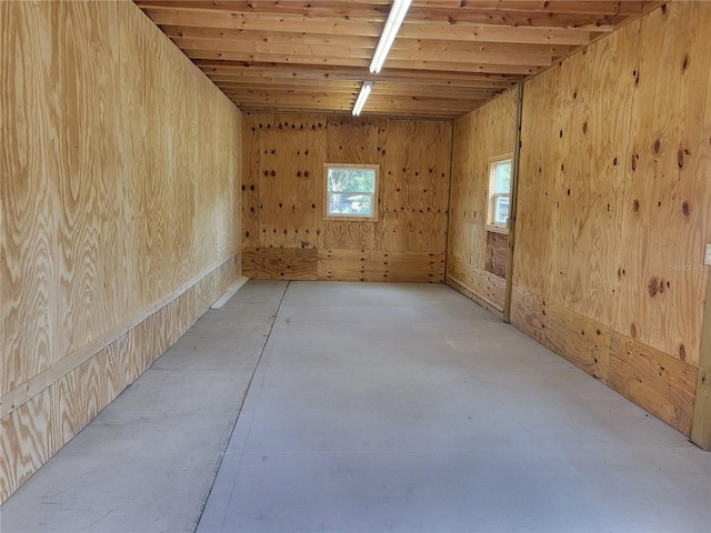 spare room featuring wood walls and wooden ceiling