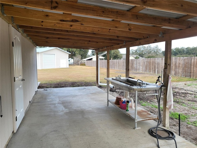 view of patio with an outbuilding