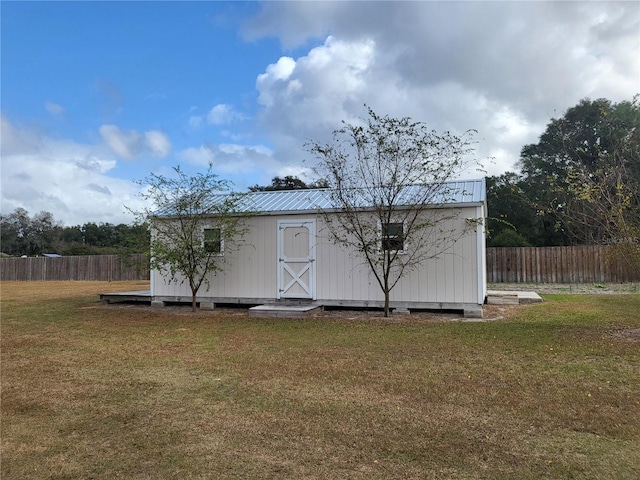 view of outbuilding featuring a yard