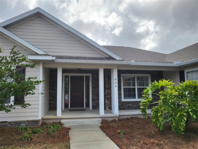 view of exterior entry with a porch