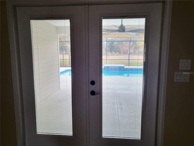 doorway to outside featuring ceiling fan and french doors