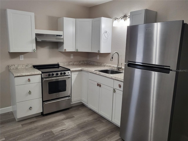 kitchen featuring white cabinets, appliances with stainless steel finishes, and sink