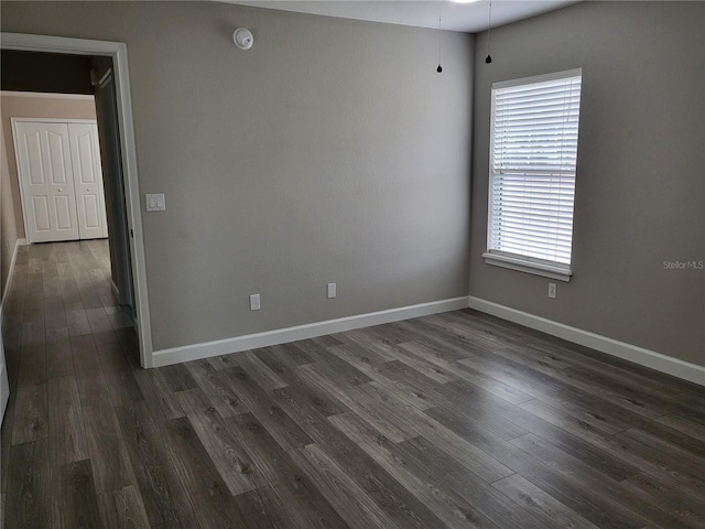 unfurnished room featuring dark hardwood / wood-style flooring