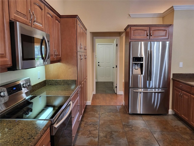 kitchen featuring dark stone countertops, dark hardwood / wood-style flooring, and stainless steel appliances