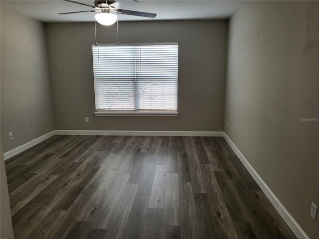 empty room featuring ceiling fan and dark hardwood / wood-style flooring