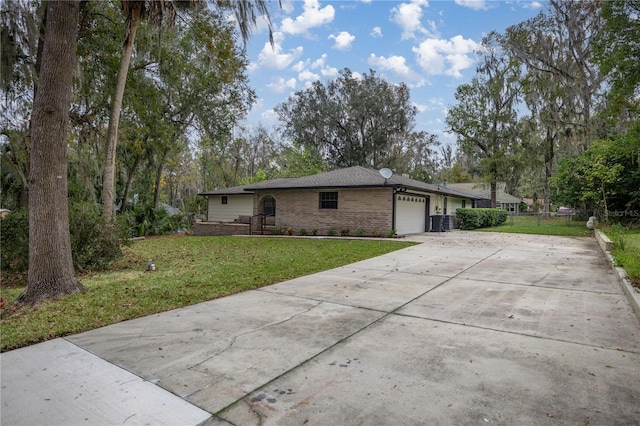 exterior space featuring a garage, central AC unit, and a lawn