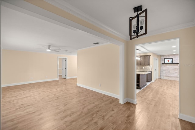 unfurnished room with light hardwood / wood-style flooring, ceiling fan, and ornamental molding