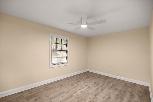 empty room with ceiling fan and light wood-type flooring