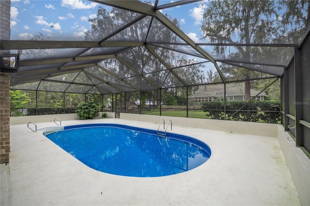 view of swimming pool with a lanai and a patio area