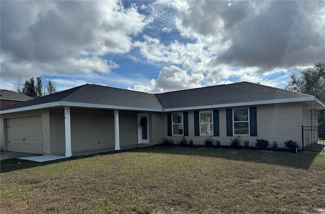 ranch-style house with a garage and a front lawn