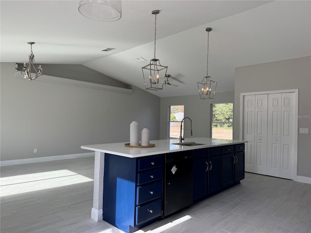 kitchen featuring a kitchen island with sink, sink, decorative light fixtures, and lofted ceiling