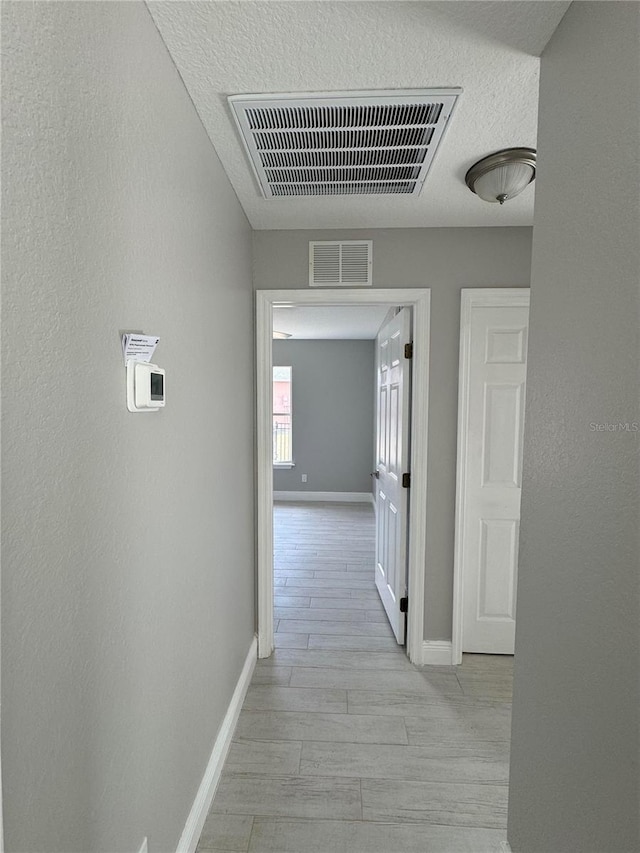 hall with light wood-type flooring