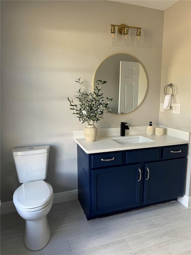 bathroom featuring hardwood / wood-style floors, vanity, and toilet