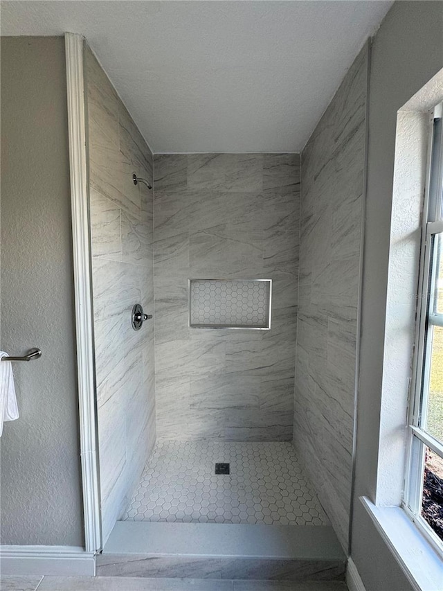 bathroom with tiled shower