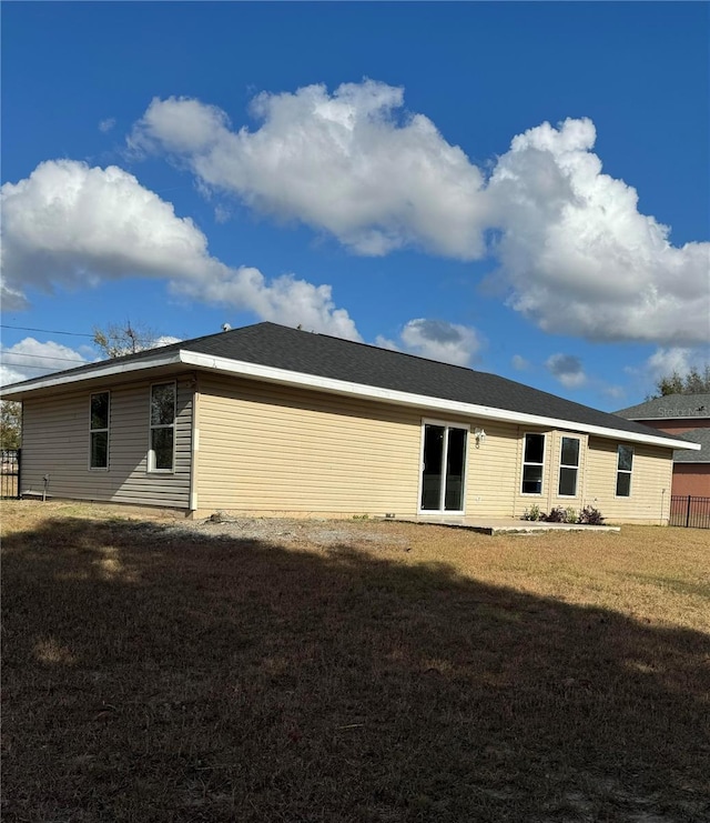 rear view of house with a lawn