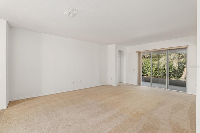 spare room with light colored carpet