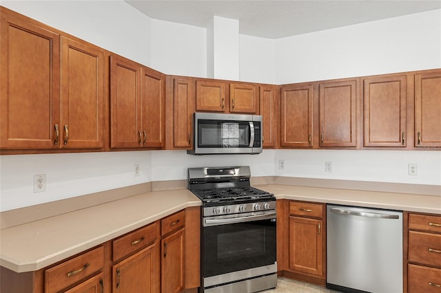 kitchen featuring light tile patterned floors and appliances with stainless steel finishes