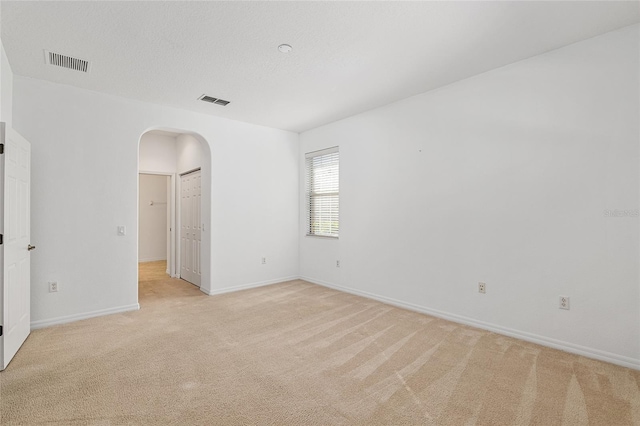 spare room with a textured ceiling