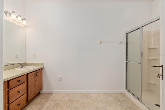 bathroom with vanity and a shower with door