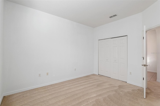 unfurnished bedroom with light colored carpet