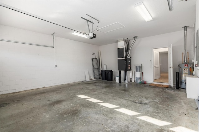 garage featuring heating unit, water heater, and a garage door opener