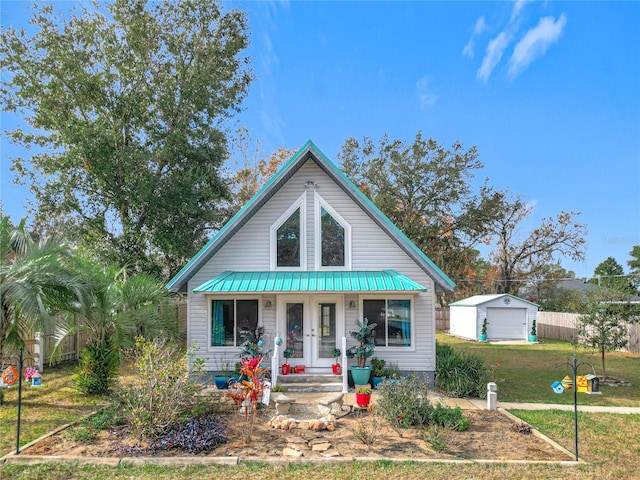 bungalow-style house with covered porch, a garage, an outdoor structure, and a front yard