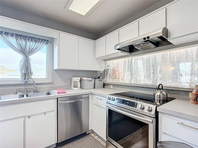 kitchen featuring sink, white cabinets, stainless steel appliances, and extractor fan