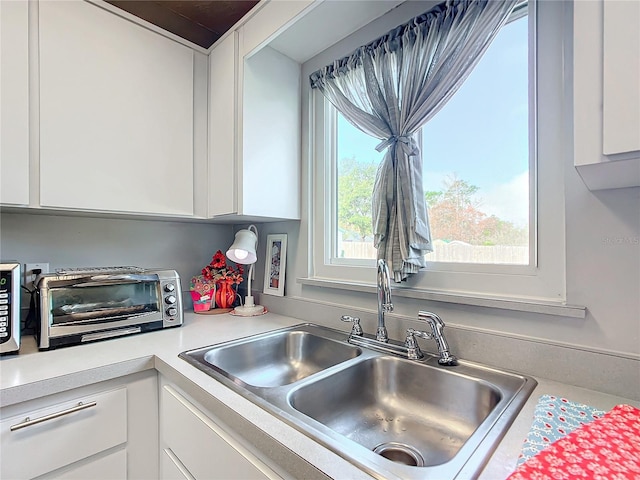 kitchen with white cabinets and sink