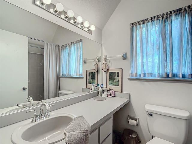 bathroom with a textured ceiling, lofted ceiling, toilet, vanity, and a shower with shower curtain