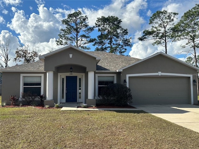 ranch-style home featuring a garage and a front yard