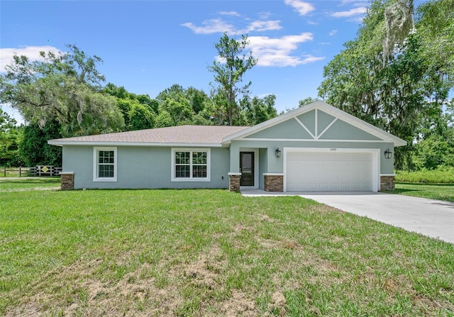 single story home featuring a garage and a front yard