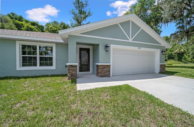 view of front of property featuring a garage and a front lawn