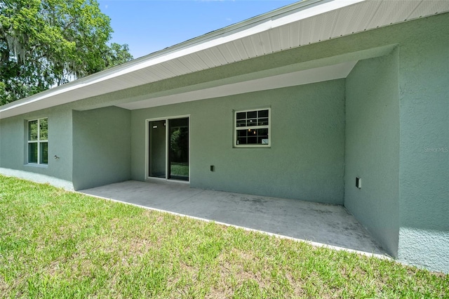 rear view of house with a yard and a patio