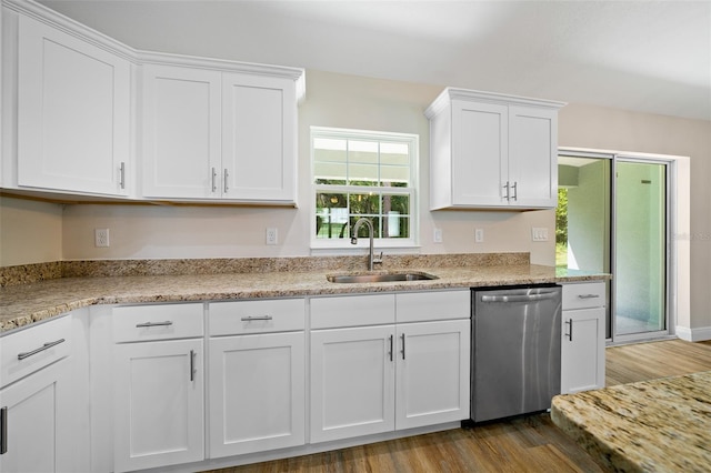 kitchen with sink, light stone counters, stainless steel dishwasher, hardwood / wood-style floors, and white cabinets