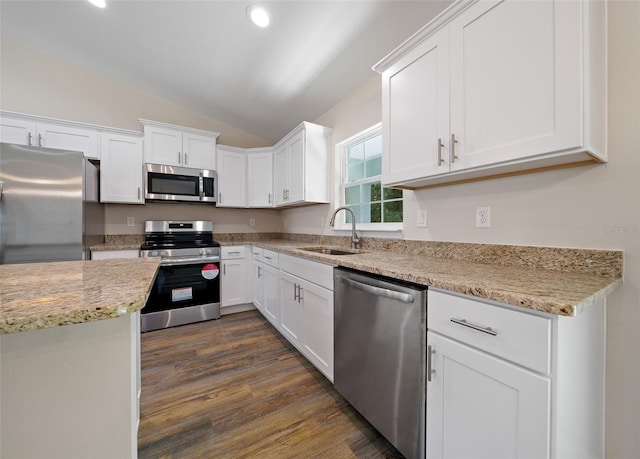 kitchen featuring white cabinetry, sink, dark hardwood / wood-style flooring, lofted ceiling, and appliances with stainless steel finishes