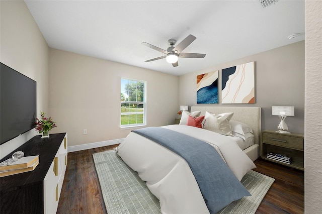 bedroom with dark hardwood / wood-style floors and ceiling fan