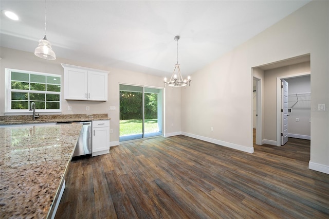 kitchen featuring light stone countertops, dark wood-type flooring, stainless steel dishwasher, pendant lighting, and white cabinets