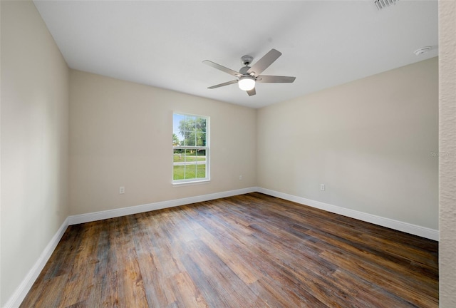 spare room with ceiling fan and dark hardwood / wood-style flooring