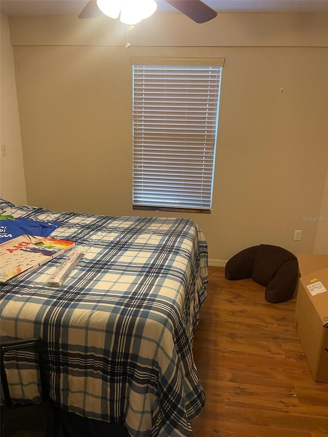 bedroom with ceiling fan and hardwood / wood-style floors