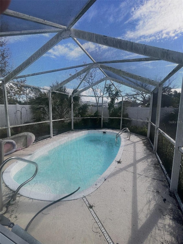 view of pool featuring a lanai and a patio